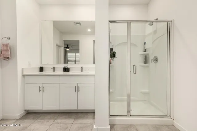 a bathroom with a shower sink and mirror