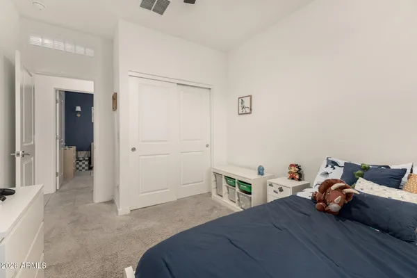 a bedroom with a bed and a cabinet