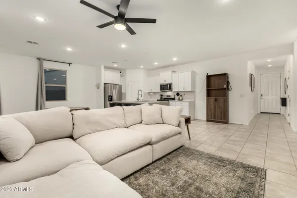 a living room with furniture and kitchen view