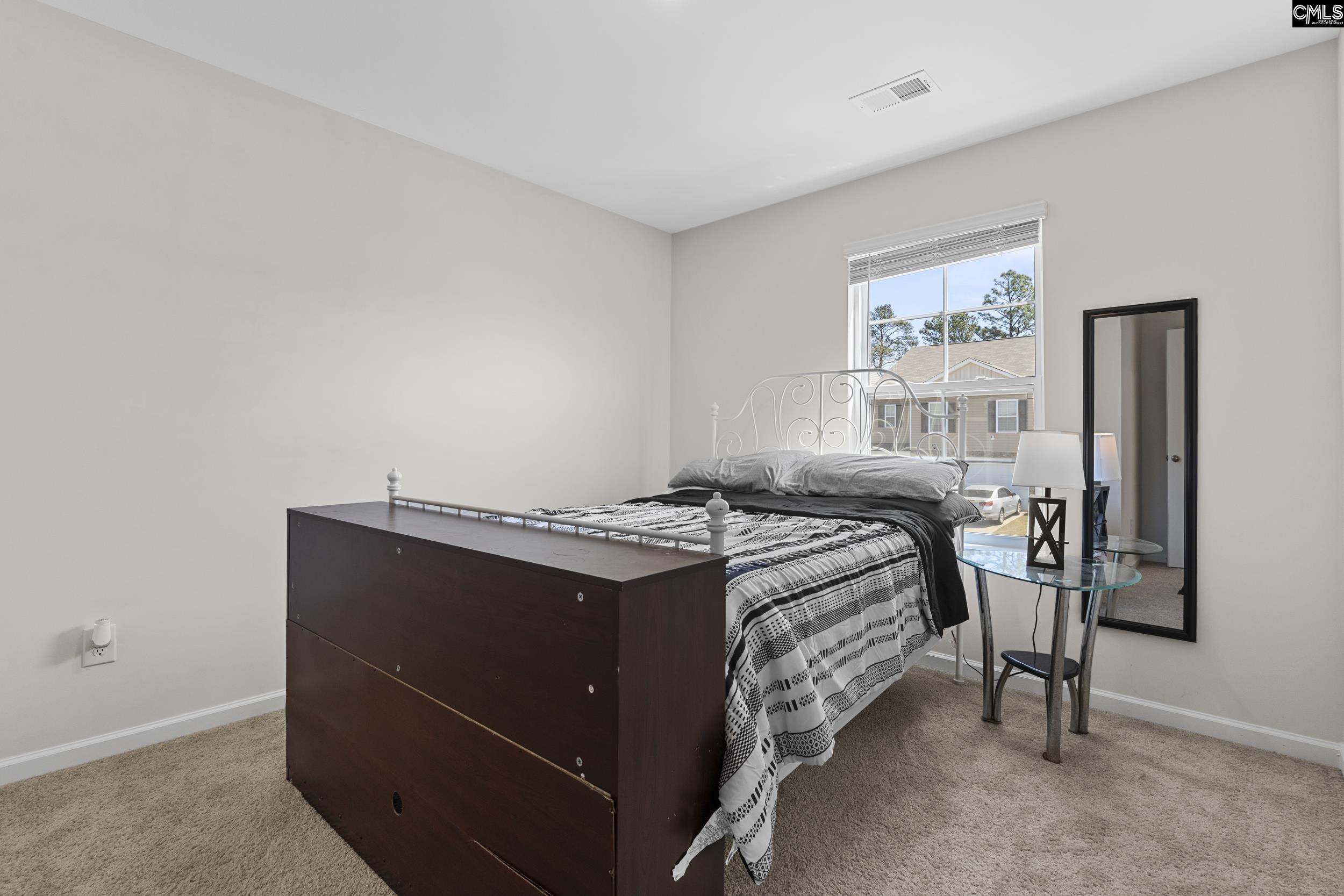 2097 Elmridge Road Columbia, SC 29209 - Photo 7 of 9 a bed sitting in a bedroom next to a window