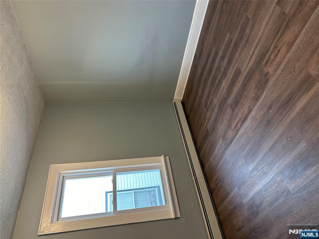 122-124 Buffalo Avenue, Unit 4 Paterson, NJ 07503 - Photo 12 of 14 an empty room with wooden floor and windows