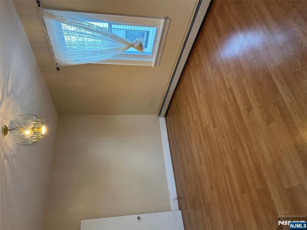122-124 Buffalo Avenue, Unit 4 Paterson, NJ 07503 - Photo 4 of 14 an empty room with wooden floor and windows