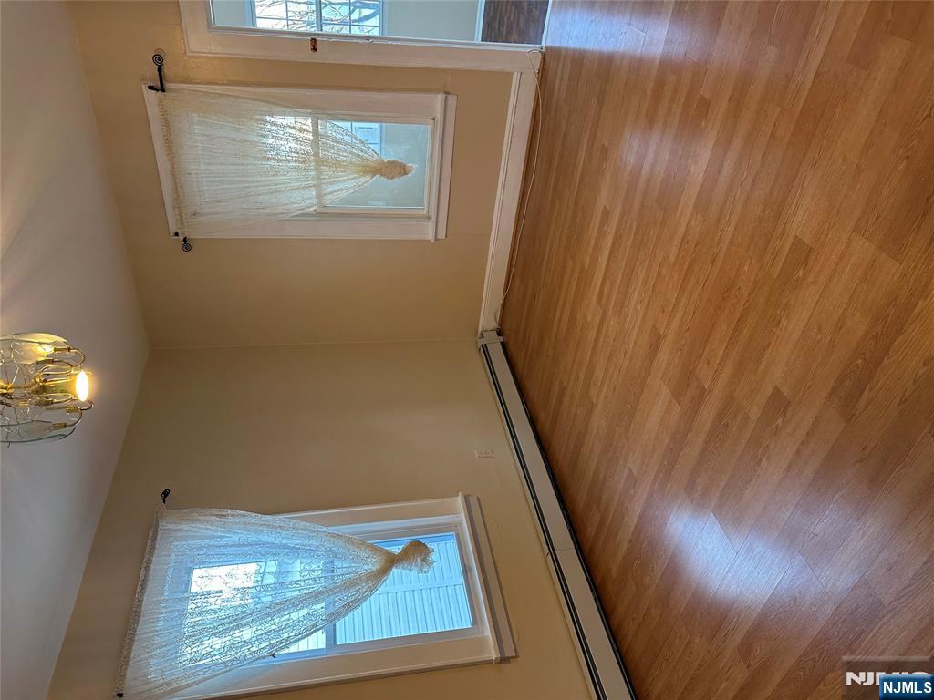 122-124 Buffalo Avenue, Unit 4 Paterson, NJ 07503 - Photo 5 of 14 an empty room with wooden floor and windows