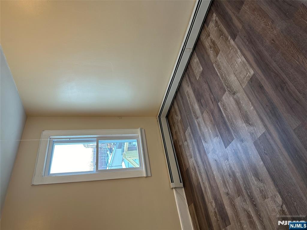 122-124 Buffalo Avenue, Unit 4 Paterson, NJ 07503 - Photo 6 of 14 an empty room with wooden floor and windows