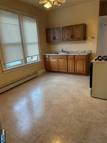 a kitchen with kitchen island a sink a stove and a refrigerator