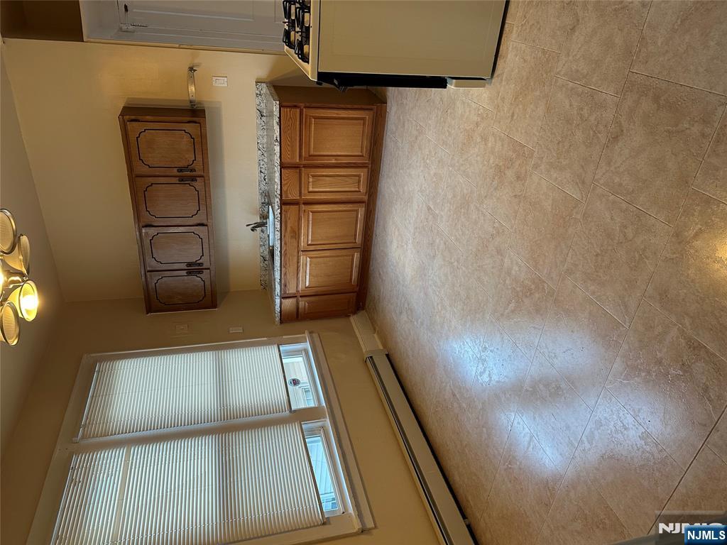 122-124 Buffalo Avenue, Unit 4 Paterson, NJ 07503 - Photo 7 of 14 a kitchen with kitchen island a sink a stove and a refrigerator
