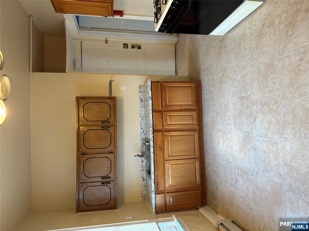 122-124 Buffalo Avenue, Unit 4 Paterson, NJ 07503 - Photo 8 of 14 a view of a kitchen with stainless steel appliances granite countertop cabinets and a sink