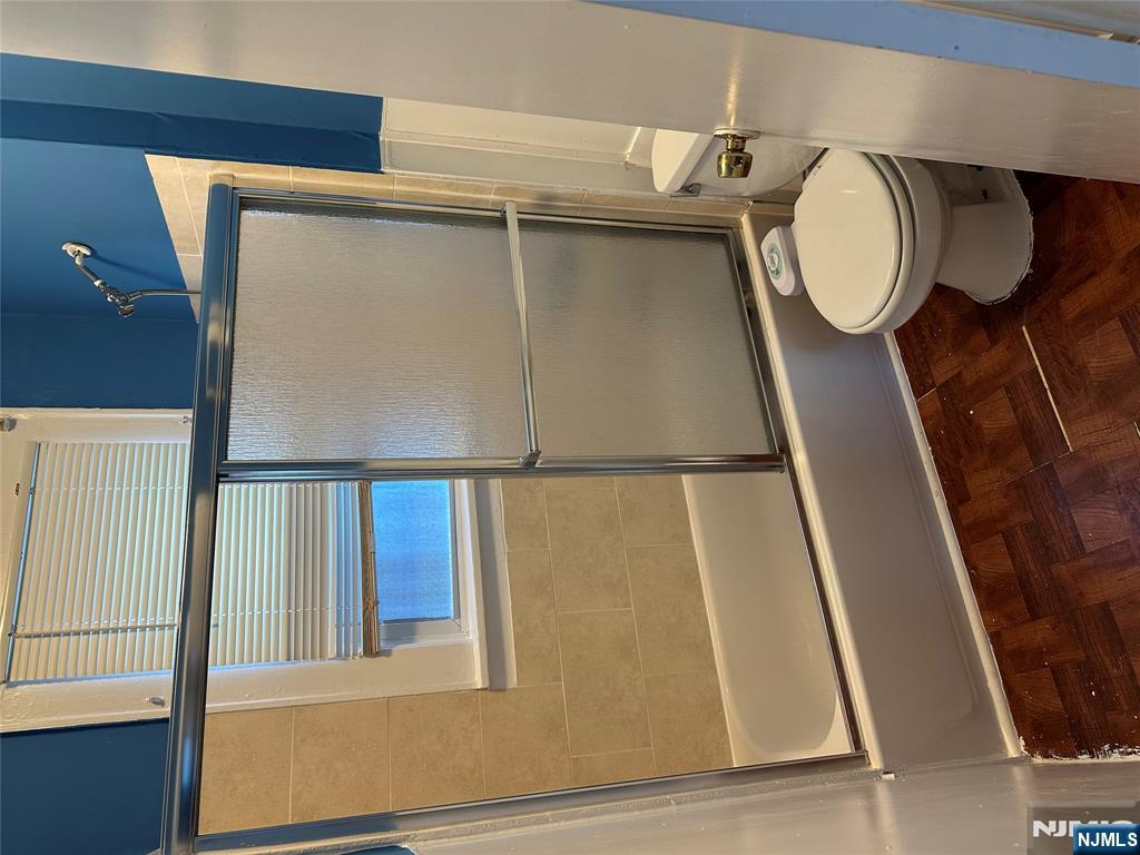 122-124 Buffalo Avenue, Unit 4 Paterson, NJ 07503 - Photo 9 of 14 a white toilet sitting next to a bathroom sink