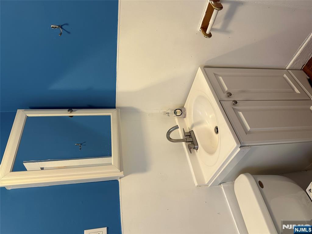 122-124 Buffalo Avenue, Unit 4 Paterson, NJ 07503 - Photo 10 of 14 a bathroom with a sink and a toilet