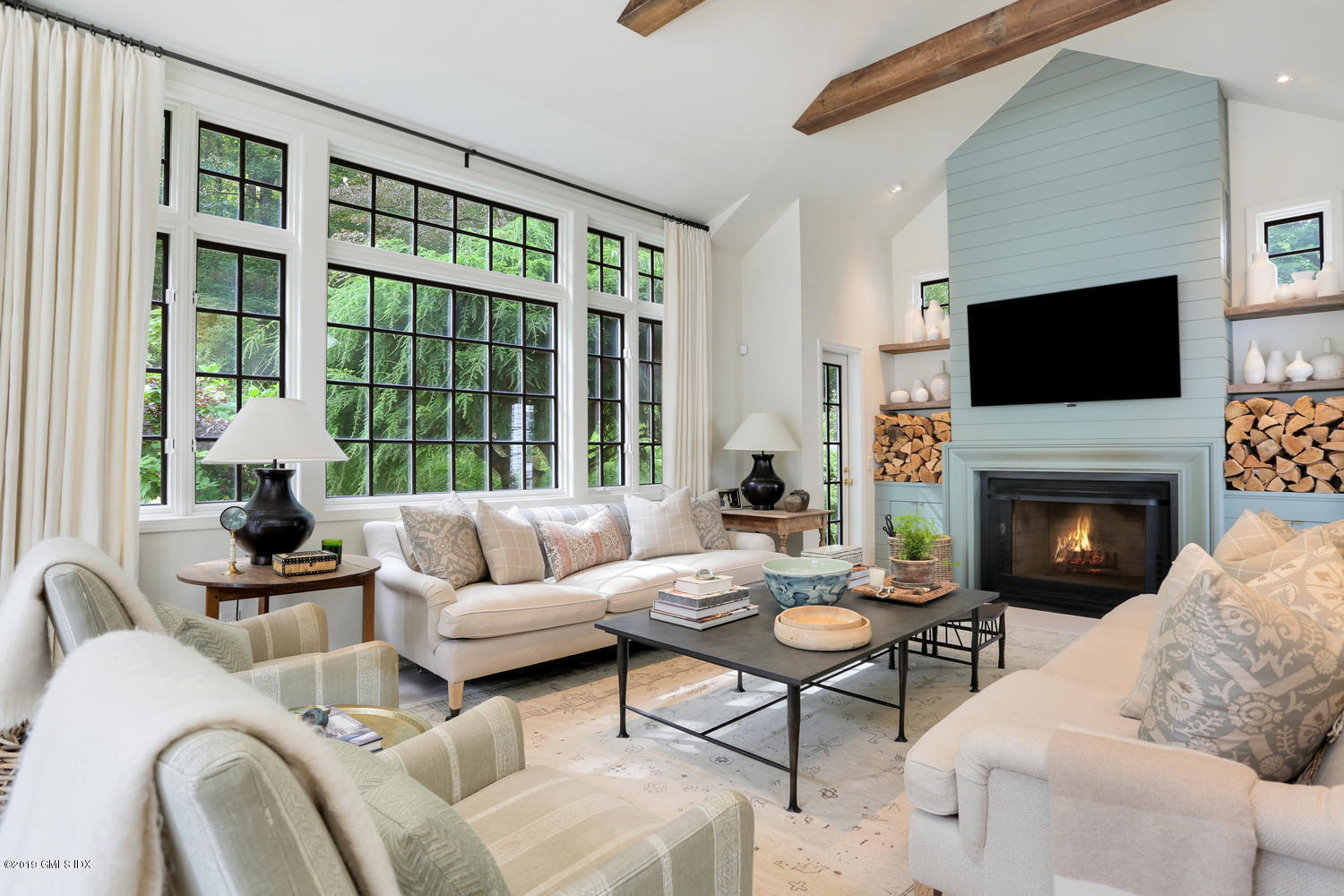 418 Riversville Road Greenwich, CT 06831 - Photo 11 of 38 a living room with furniture a flat screen tv and a fireplace