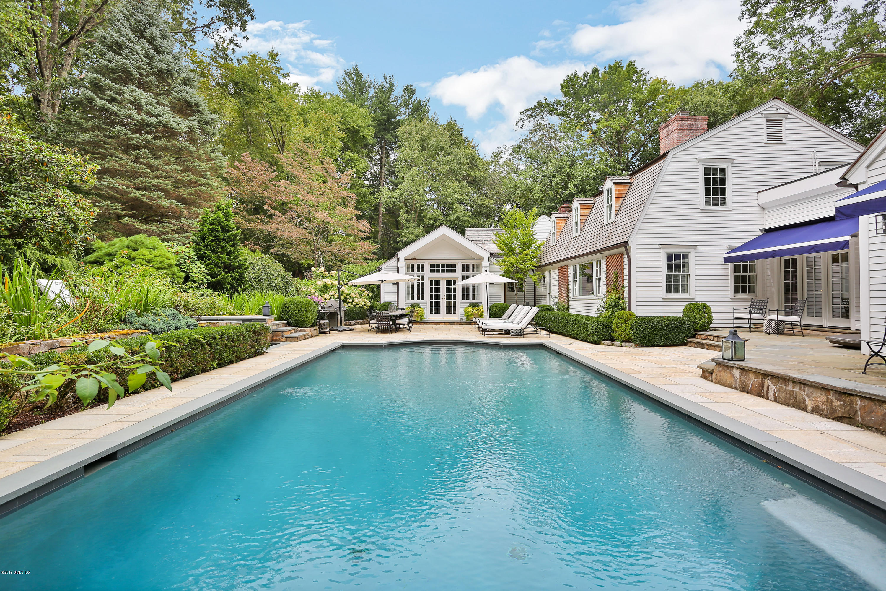 418 Riversville Road Greenwich, CT 06831 - Photo 2 of 38 a front view of a house with swimming pool and porch