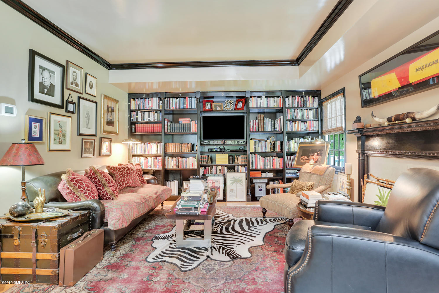 418 Riversville Road Greenwich, CT 06831 - Photo 30 of 38 a living room with furniture a flat screen tv and a floor to ceiling window