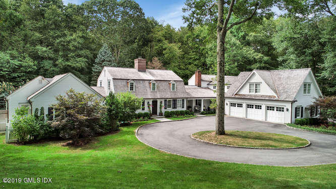 418 Riversville Road Greenwich, CT 06831 - Photo 3 of 38 a front view of a house with a yard and green space