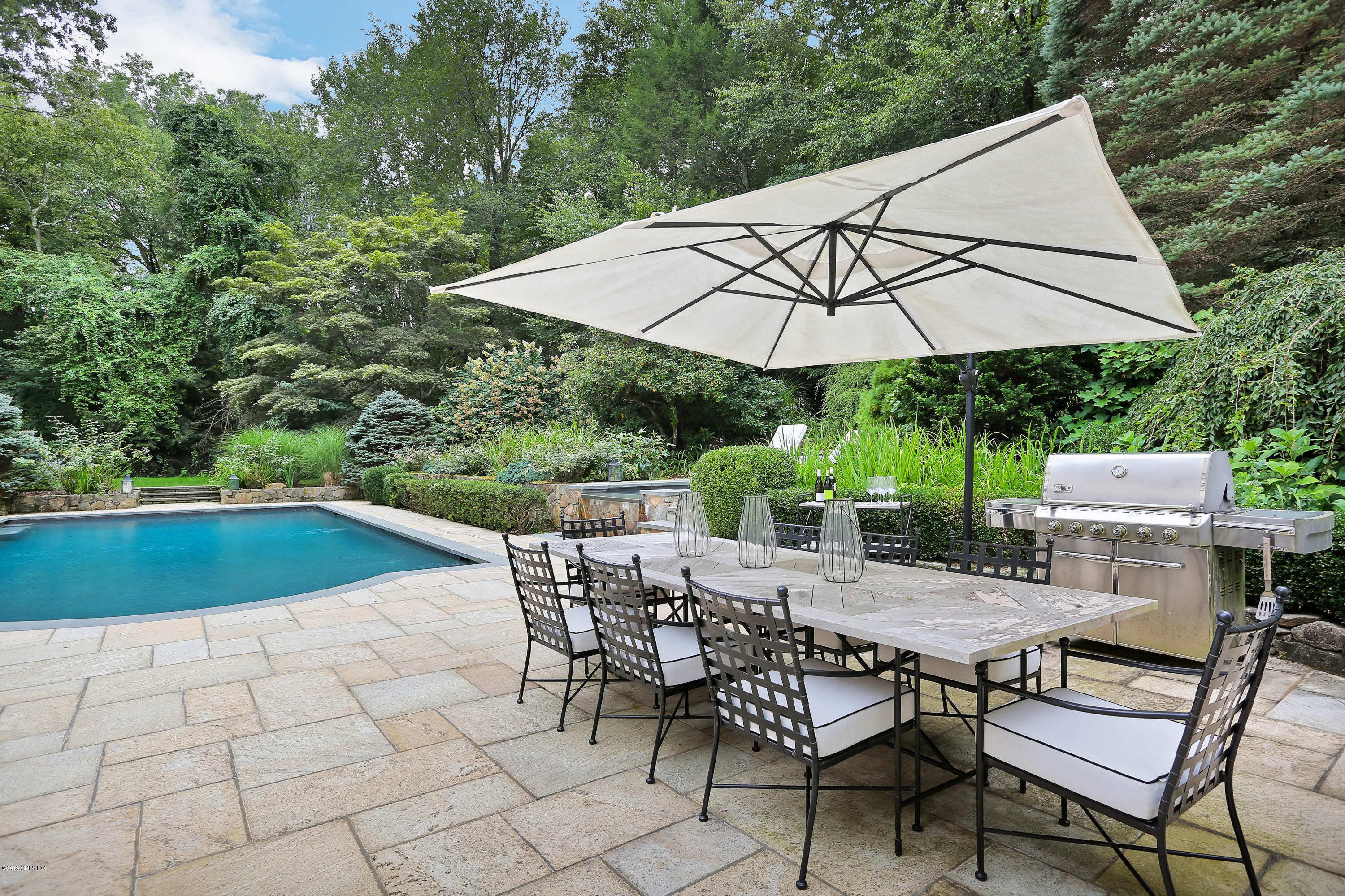 418 Riversville Road Greenwich, CT 06831 - Photo 32 of 38 an outdoor space with furniture and umbrella