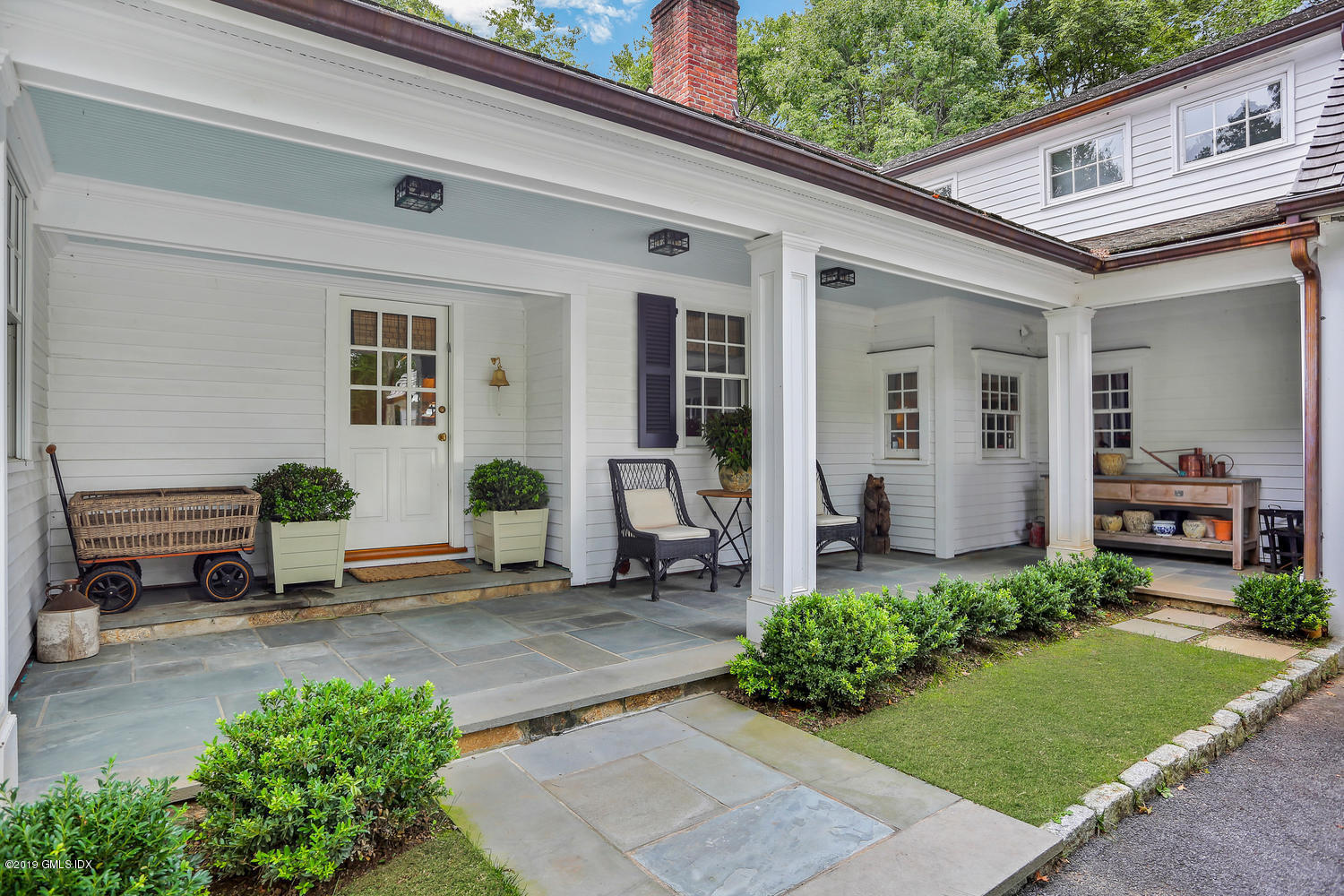 418 Riversville Road Greenwich, CT 06831 - Photo 4 of 38 a front view of a house with garden