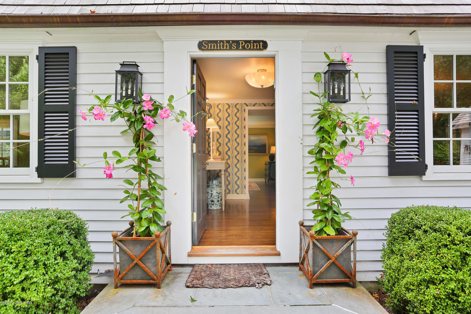 418 Riversville Road Greenwich, CT 06831 - Photo 5 of 38 a front view of a house with a garden