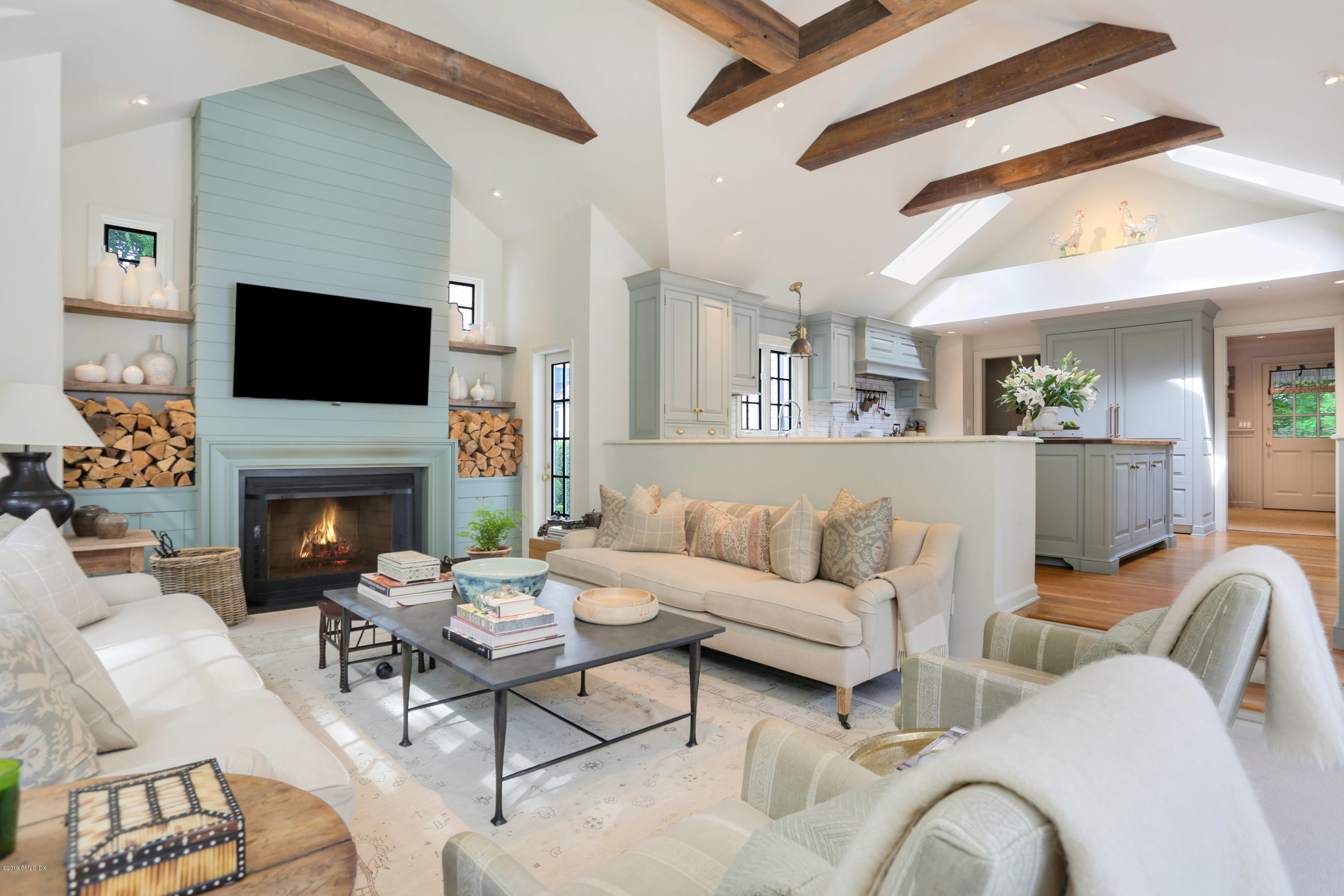418 Riversville Road Greenwich, CT 06831 - Photo 9 of 38 a living room with furniture a flat screen tv and a fireplace