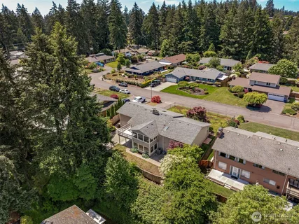 an aerial view of a house with swimming pool and outdoor seating