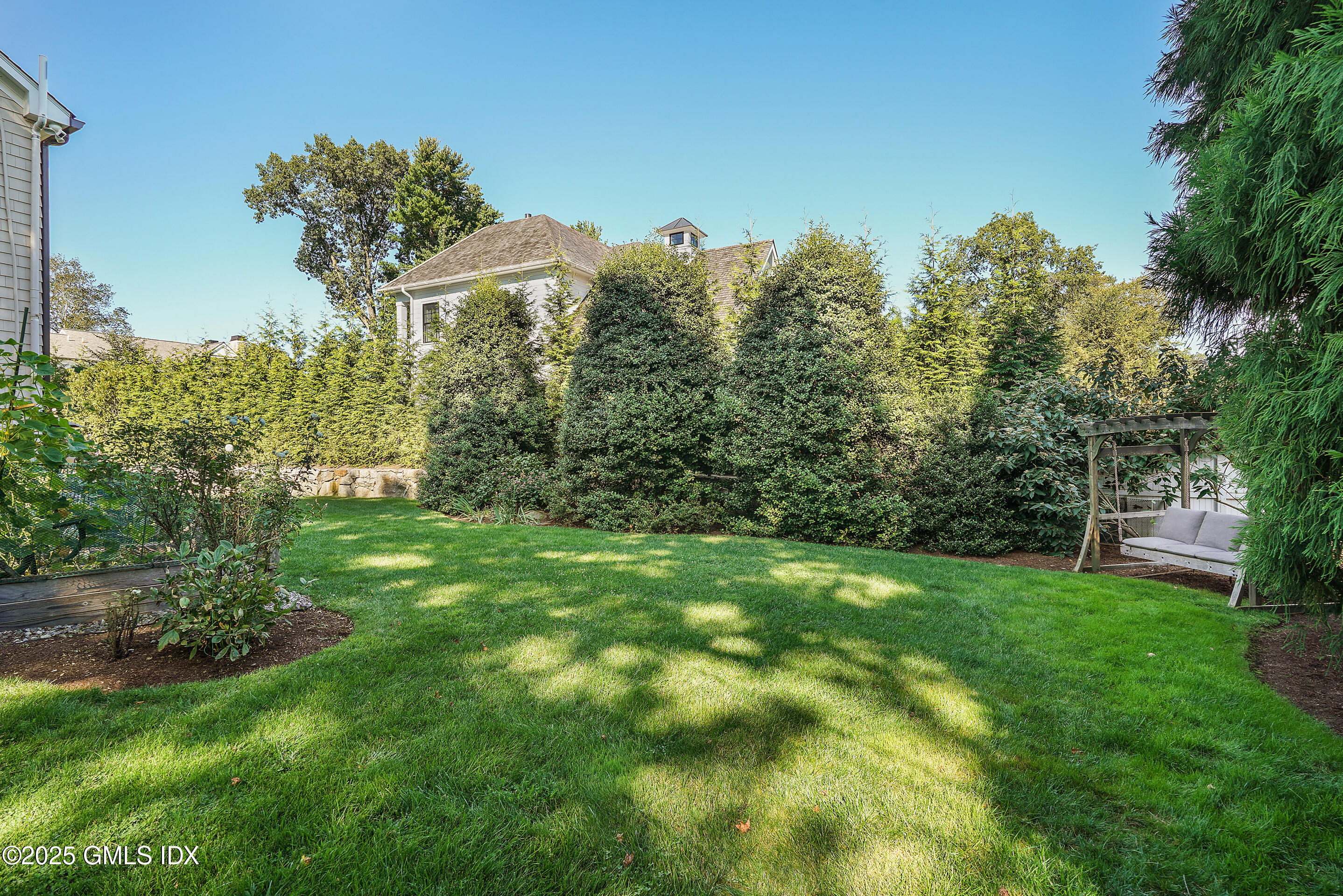 41 Winthrop Drive Riverside, CT 06878 - Photo 7 of 8 a view of a garden with a building in the background
