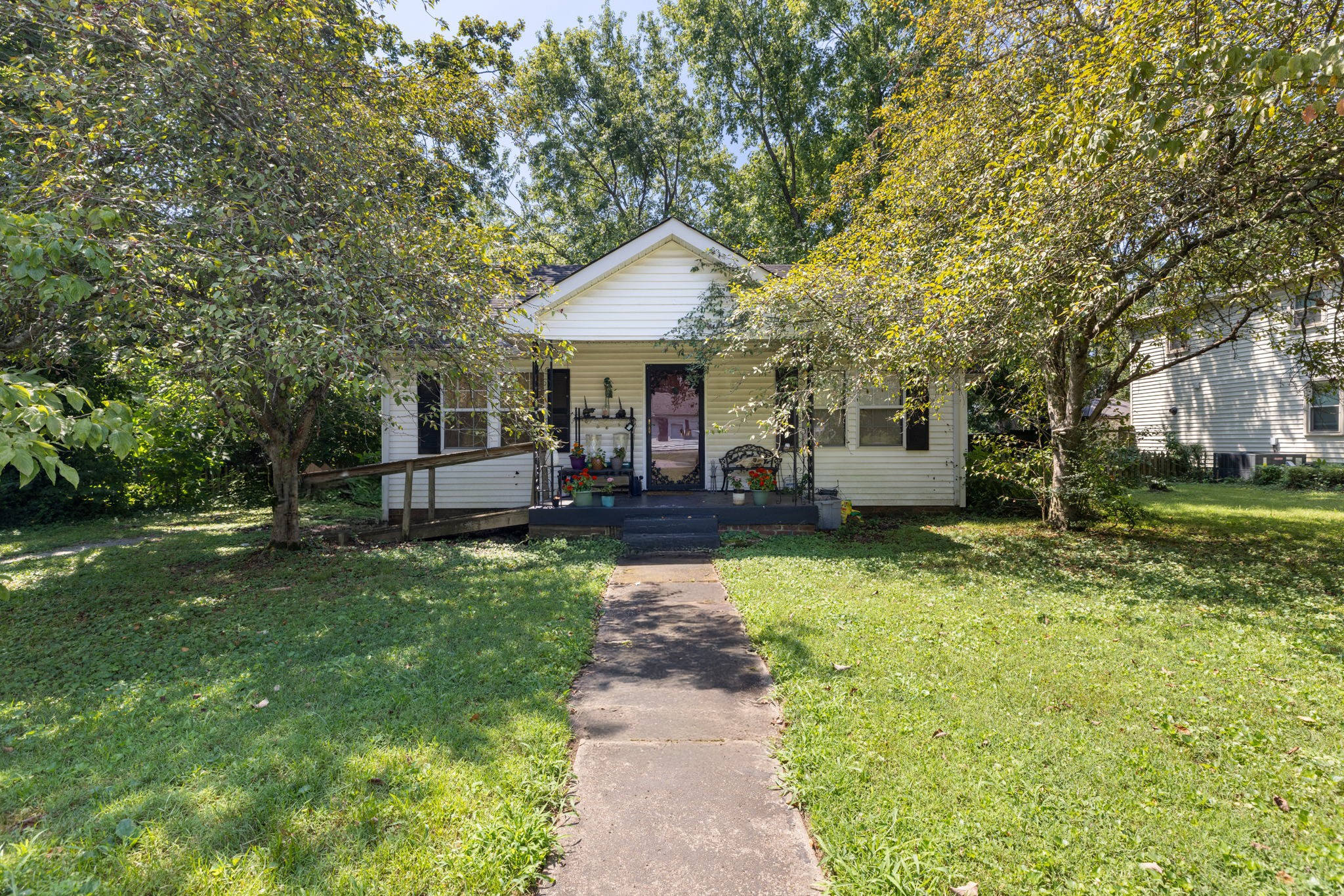 532 East Maple Street Madison, TN 37115 - Photo 1 of 14 a front view of a house with garden and trees