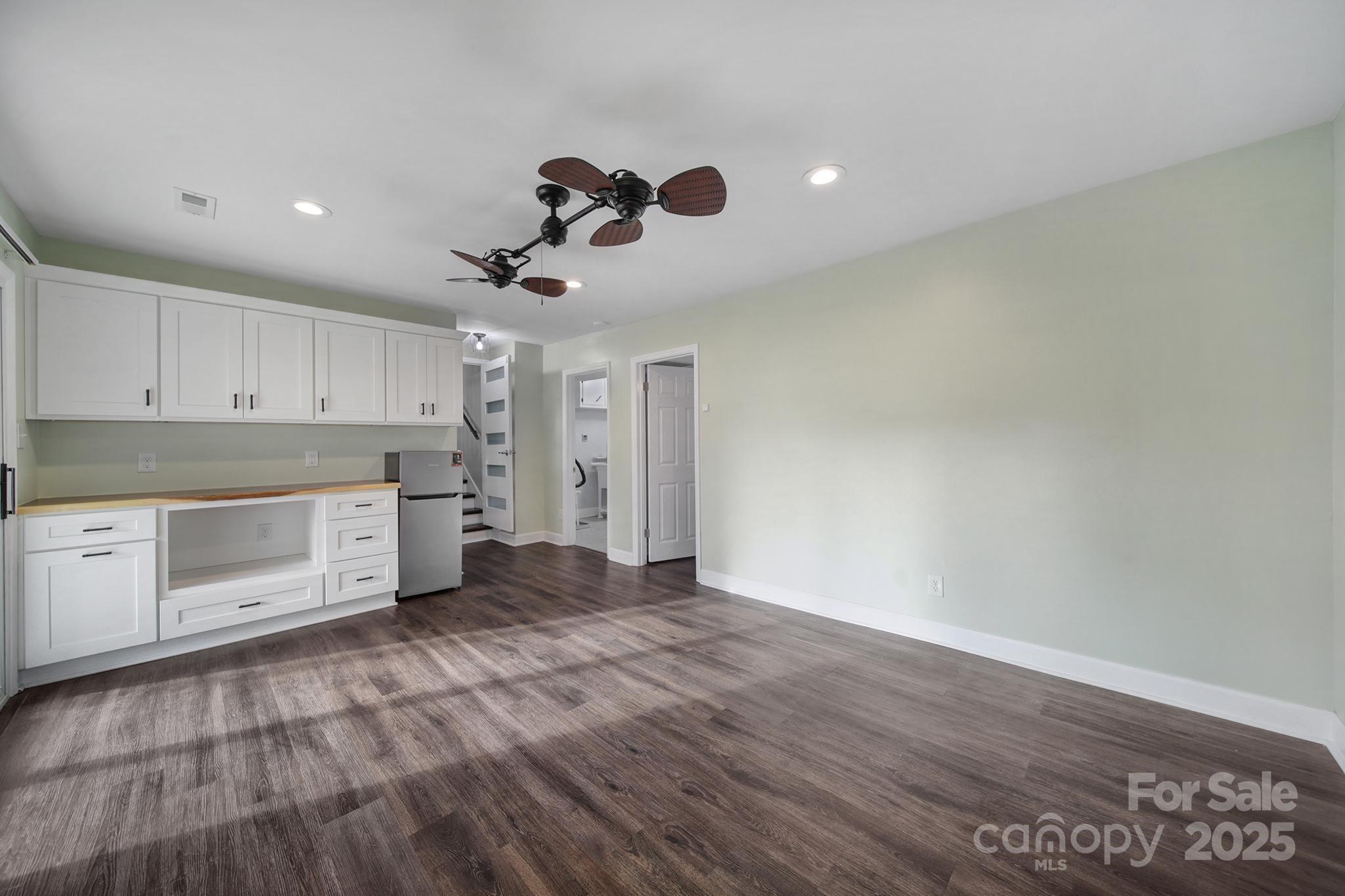 1019 Palmyra Drive Tega Cay, SC 29708 - Photo 11 of 42 a large kitchen with cabinets wooden floor and stainless steel appliances