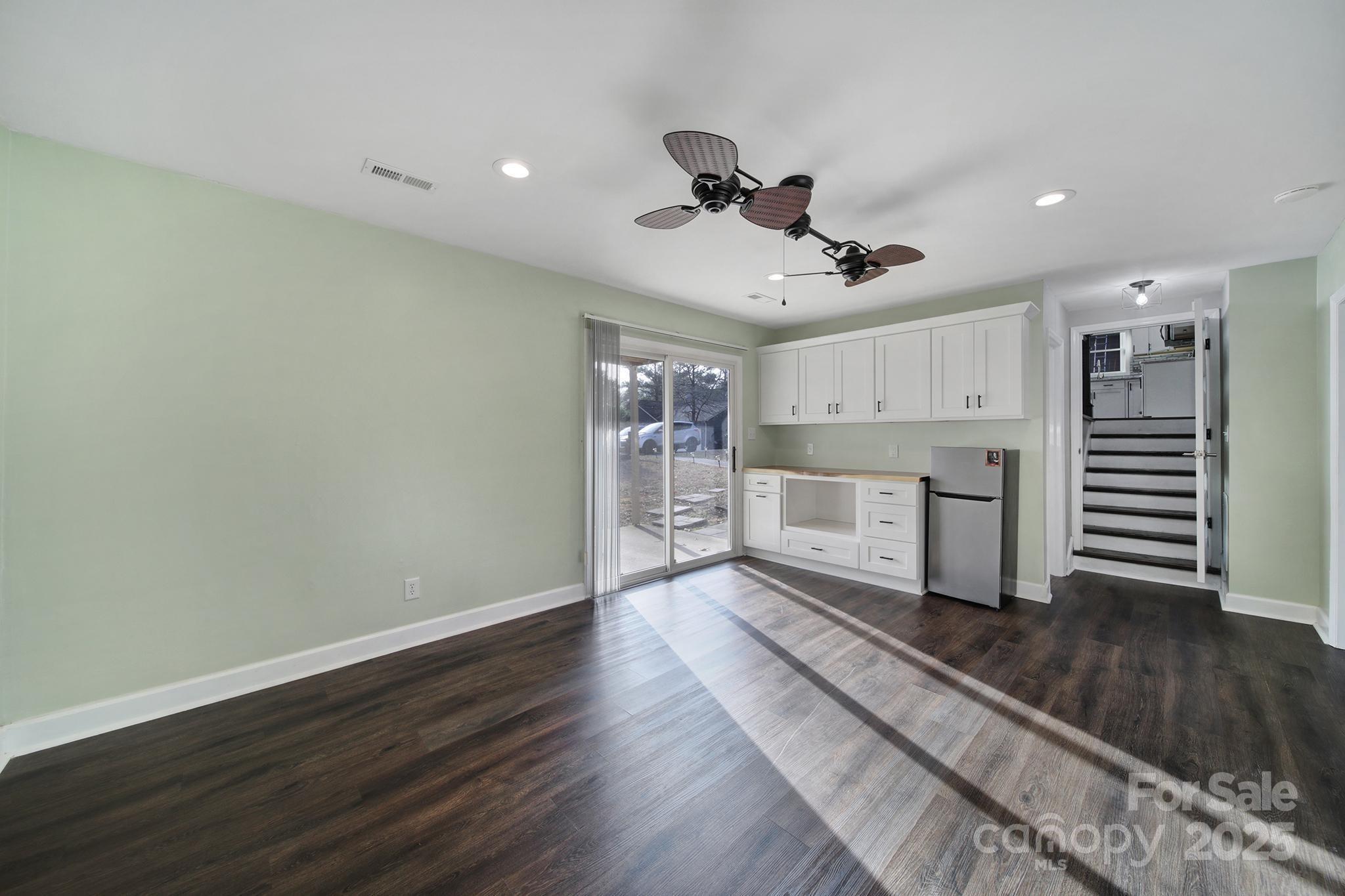 1019 Palmyra Drive Tega Cay, SC 29708 - Photo 12 of 42 a view of a kitchen with wooden floor electronic appliances and furniture