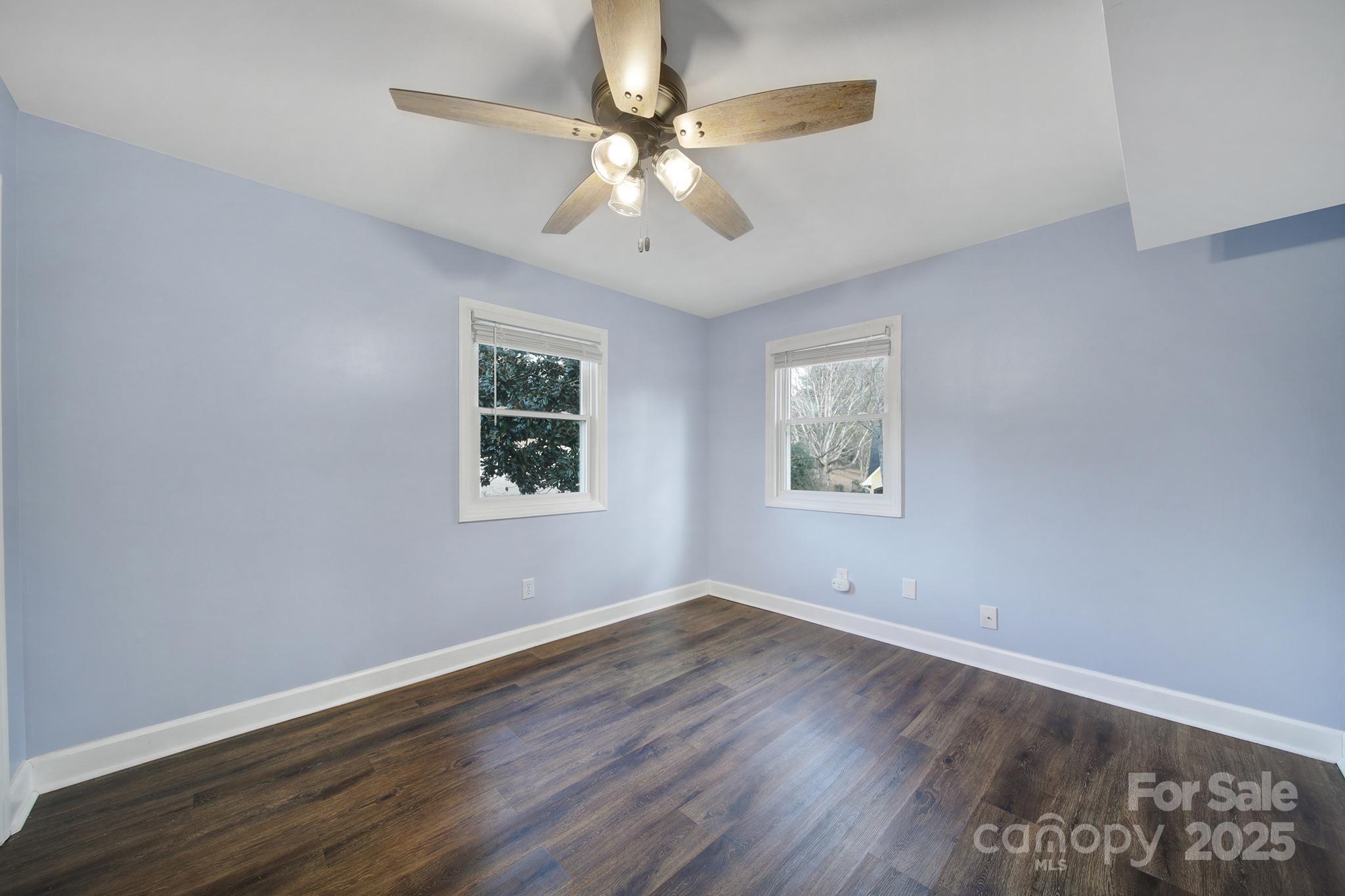 1019 Palmyra Drive Tega Cay, SC 29708 - Photo 14 of 42 a view of an empty room with wooden floor and a window