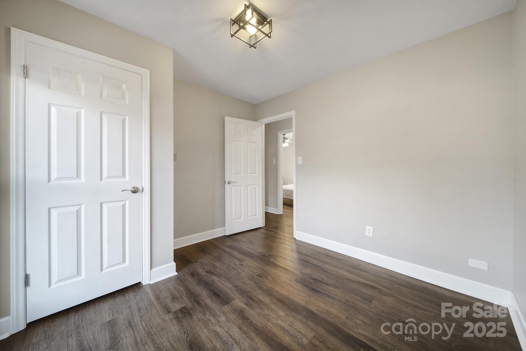 1019 Palmyra Drive Tega Cay, SC 29708 - Photo 20 of 42 a view of an empty room with a window and wooden floor