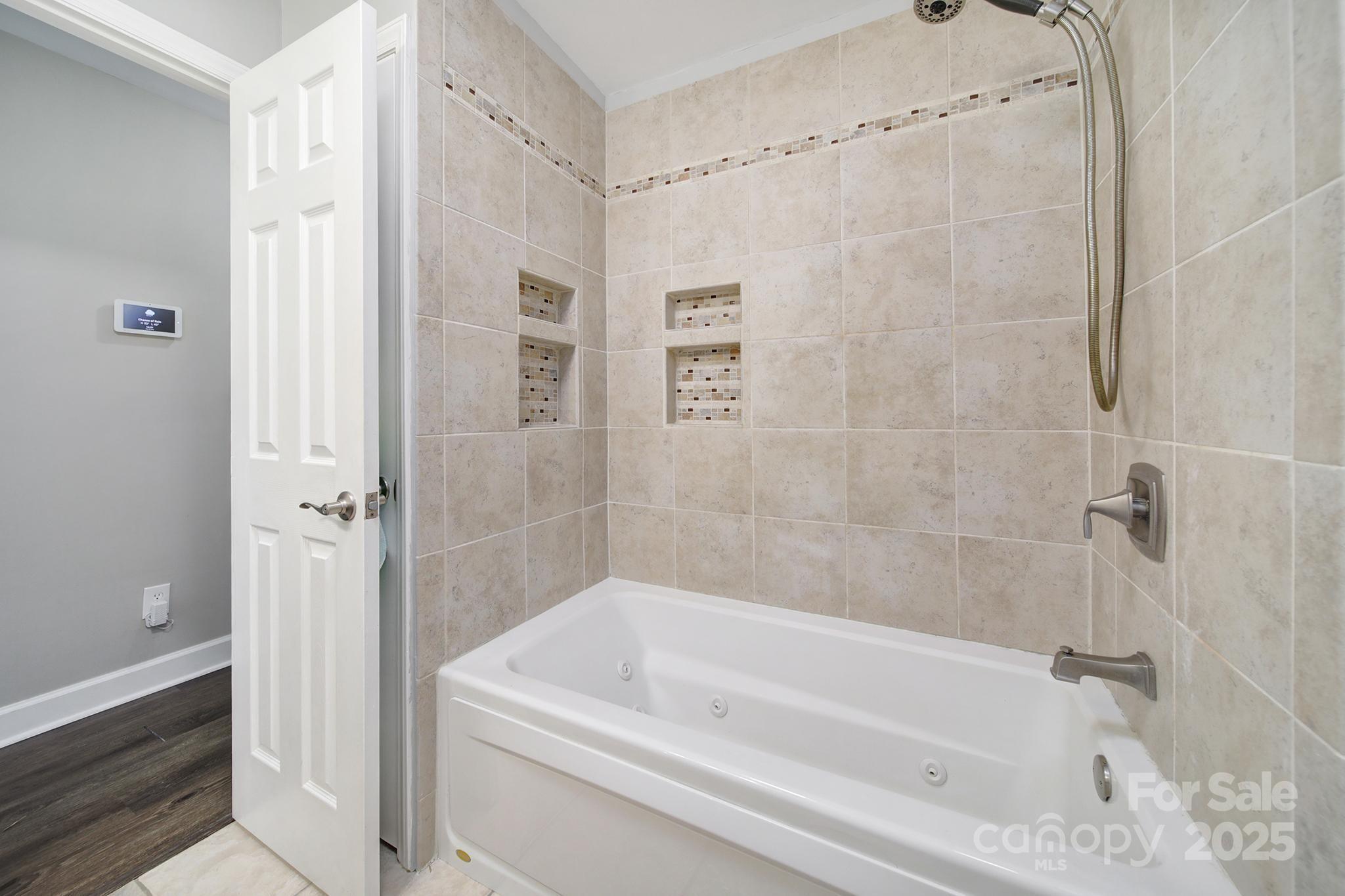 1019 Palmyra Drive Tega Cay, SC 29708 - Photo 22 of 42 a bathroom with a bathtub