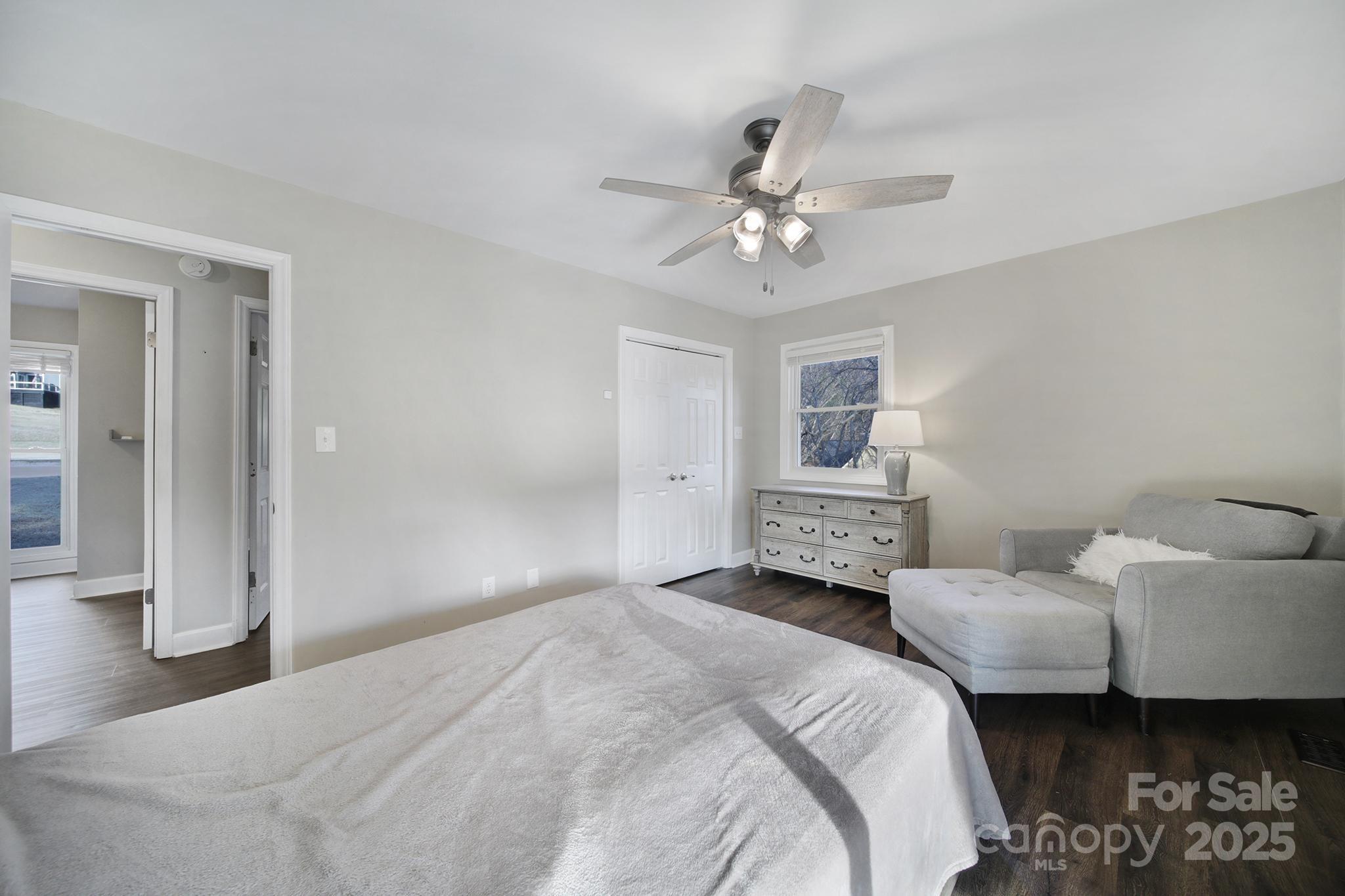1019 Palmyra Drive Tega Cay, SC 29708 - Photo 25 of 42 a bedroom with a bed ceiling fan and a wooden floor