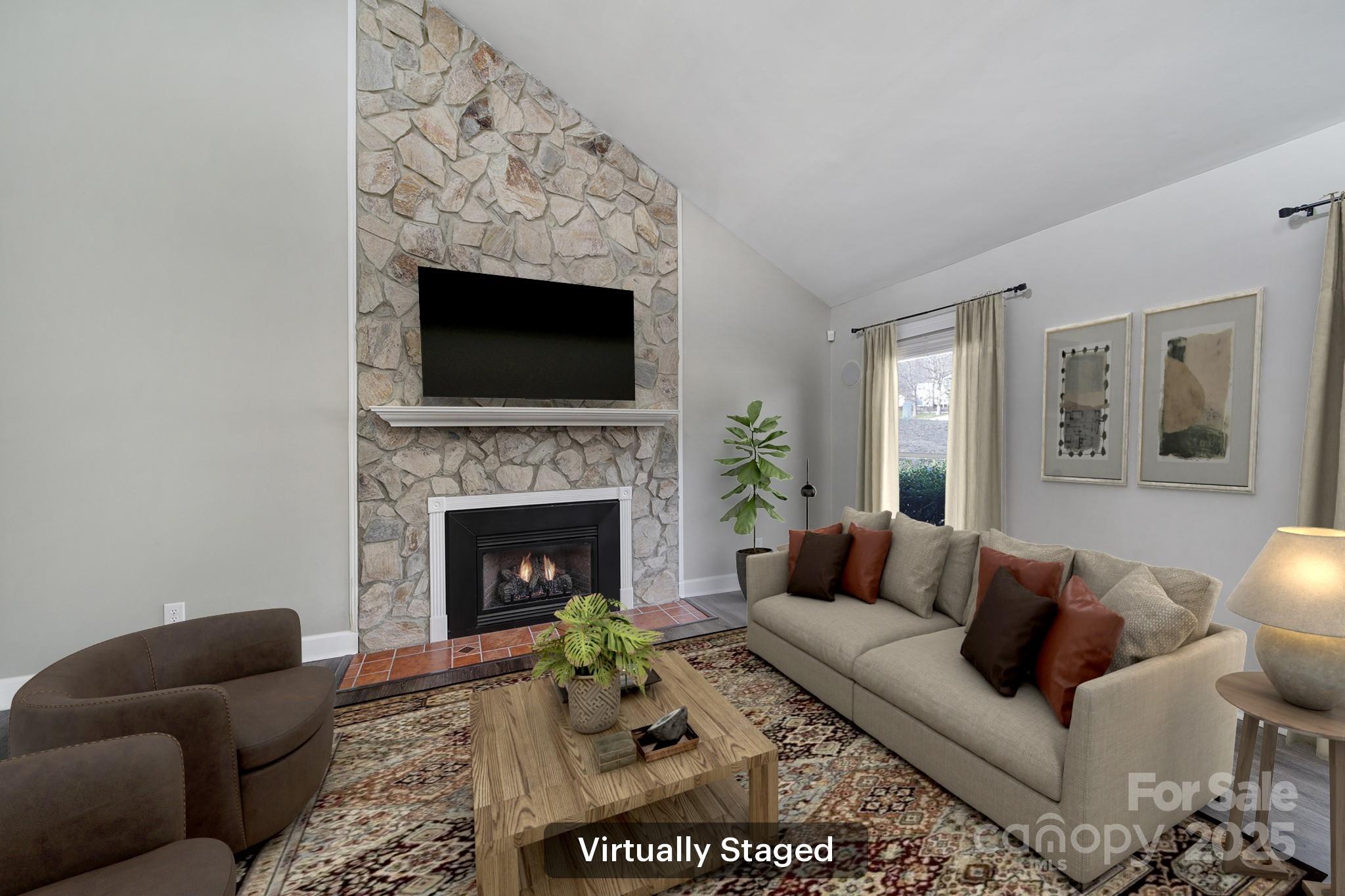 1019 Palmyra Drive Tega Cay, SC 29708 - Photo 4 of 42 a living room with furniture a flat screen tv and a fireplace