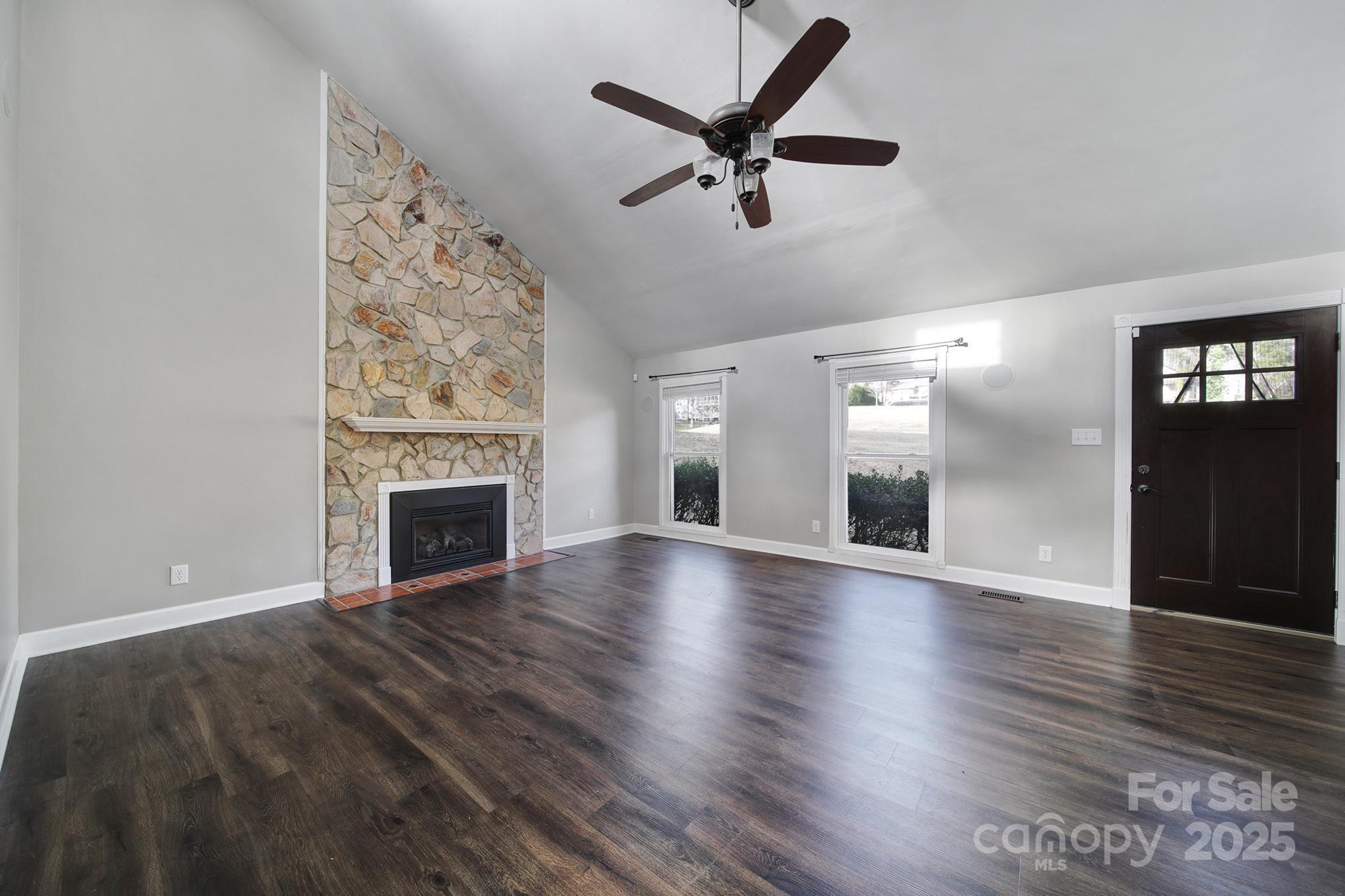 1019 Palmyra Drive Tega Cay, SC 29708 - Photo 6 of 42 a view of empty room with wooden floor and fireplace