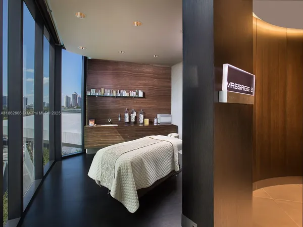 a view of an empty room with floor to ceiling window and an entryway