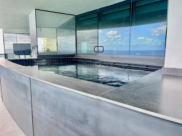 a room with stainless steel appliances kitchen island granite countertop furniture and a kitchen view