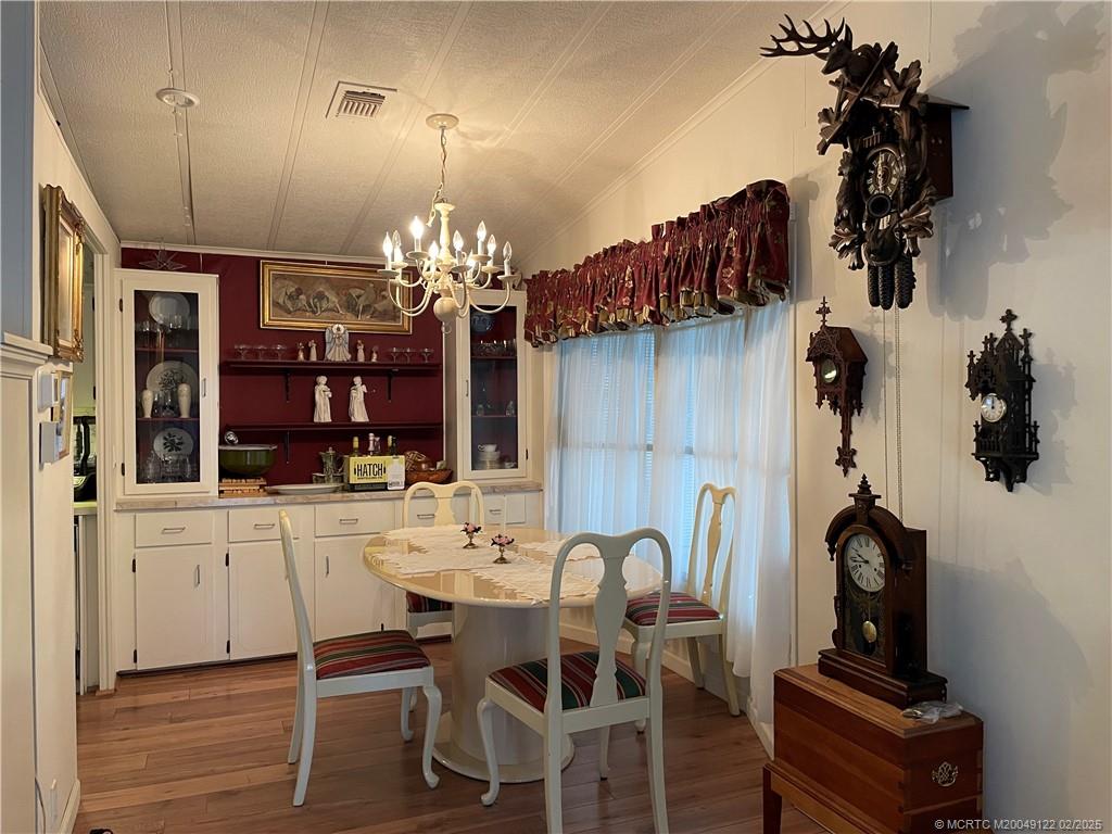 14663 Southwest Rake Drive Indiantown, FL 34956 - Photo 14 of 36 a view of a dining room with furniture and chandelier