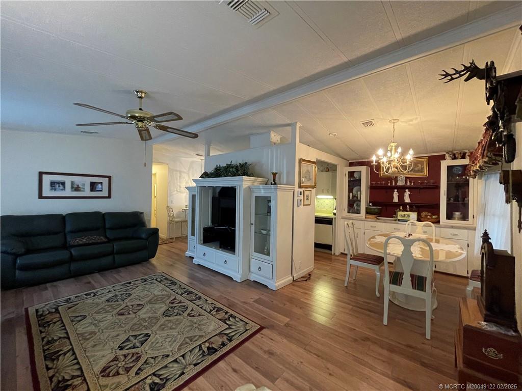 14663 Southwest Rake Drive Indiantown, FL 34956 - Photo 18 of 36 a living room with furniture and a fireplace