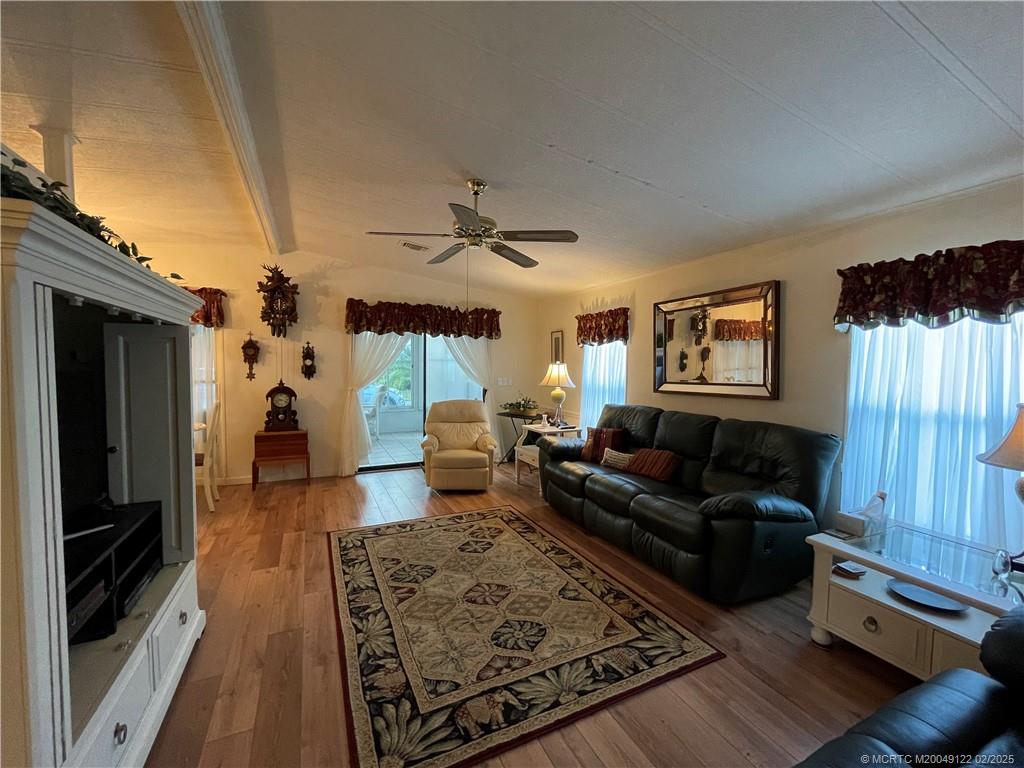 14663 Southwest Rake Drive Indiantown, FL 34956 - Photo 20 of 36 a living room with furniture and a fireplace