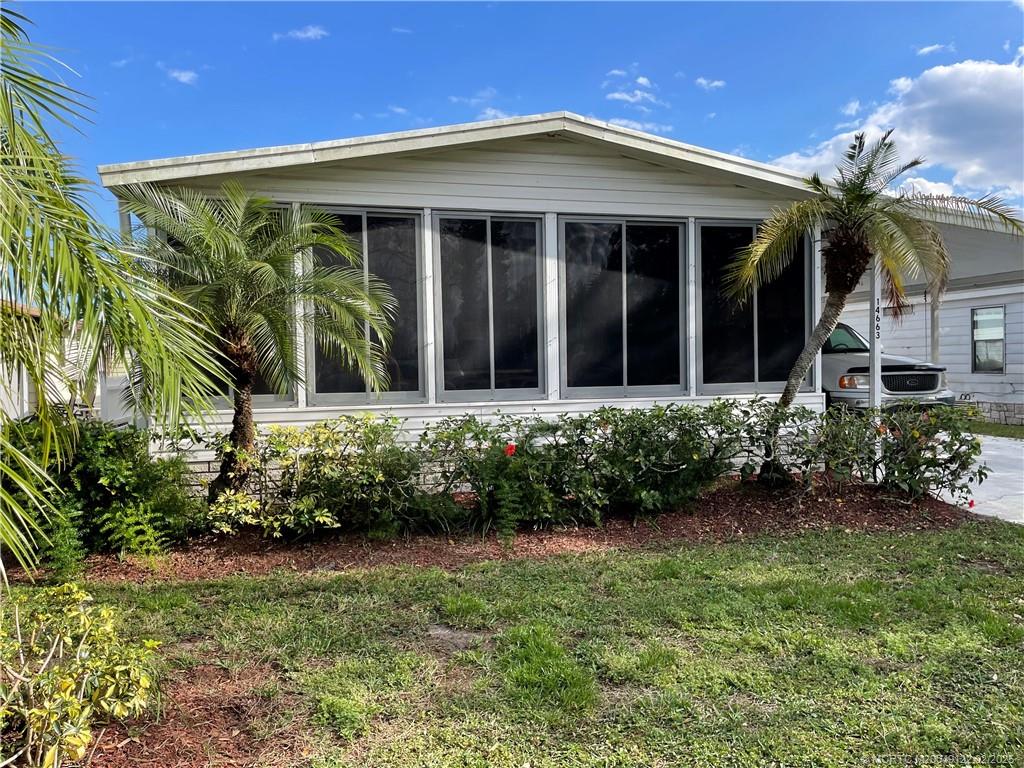 14663 Southwest Rake Drive Indiantown, FL 34956 - Photo 3 of 36 front view of a house with a yard