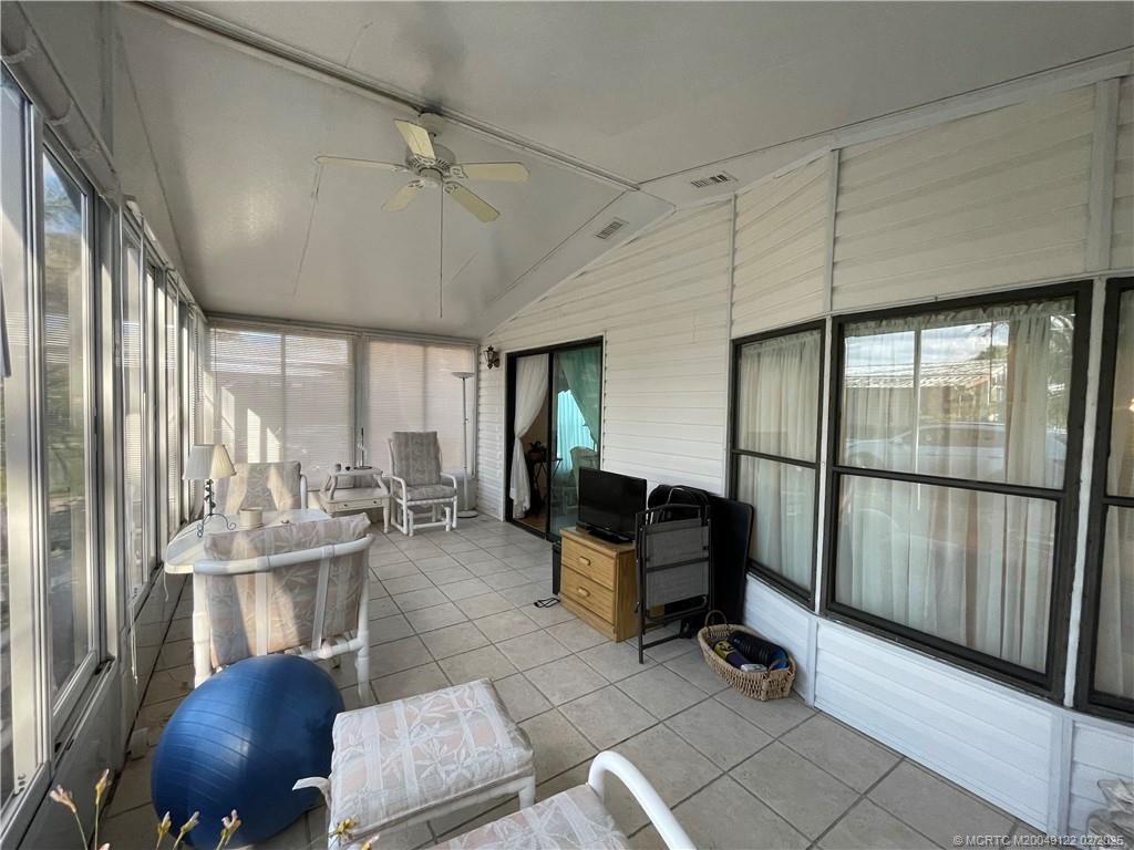 14663 Southwest Rake Drive Indiantown, FL 34956 - Photo 5 of 36 a room with lots of furniture and a chandelier