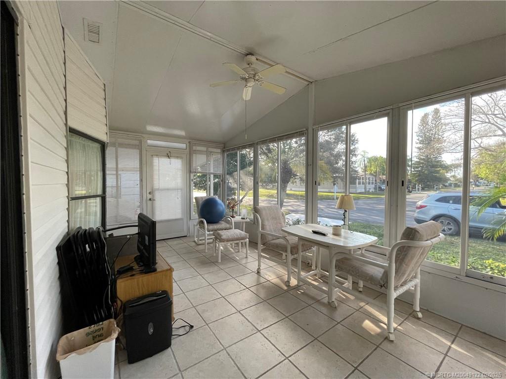 14663 Southwest Rake Drive Indiantown, FL 34956 - Photo 7 of 36 a living room with furniture and a floor to ceiling window