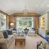 a living room with furniture fireplace and a large window