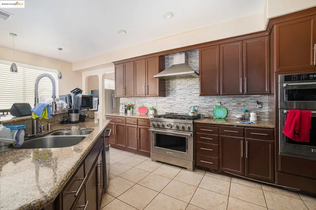 a kitchen with granite countertop a sink and cabinets