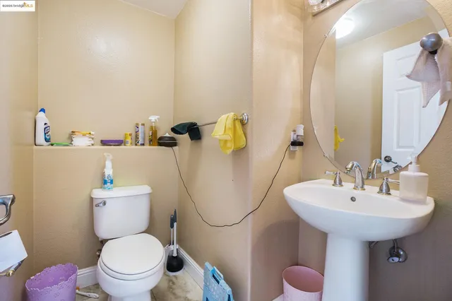 a bathroom with a sink toilet and mirror