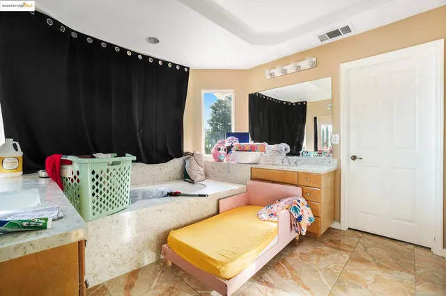 a bedroom with a bed and a couch