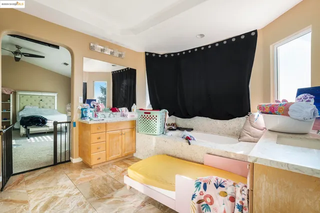 a bedroom with a bed dresser and mirror