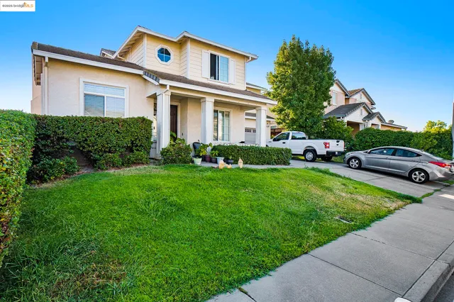 a front view of a house with a garden and plants
