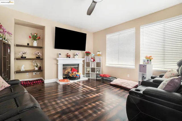 a living room with furniture a flat screen tv and a fireplace