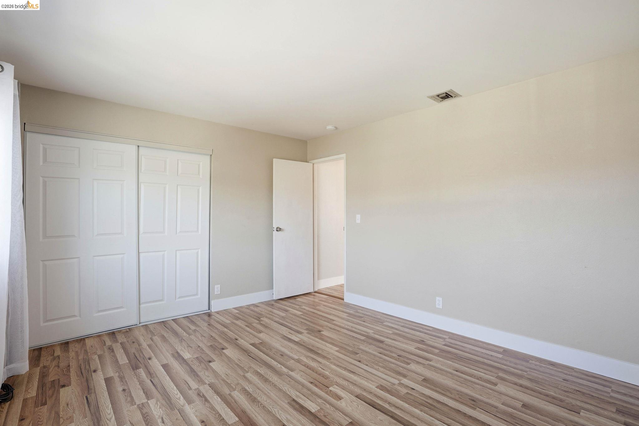 840 Key Rte Boulevard Albany, CA 94706 - Photo 26 of 42 a view of an empty room with wooden floor