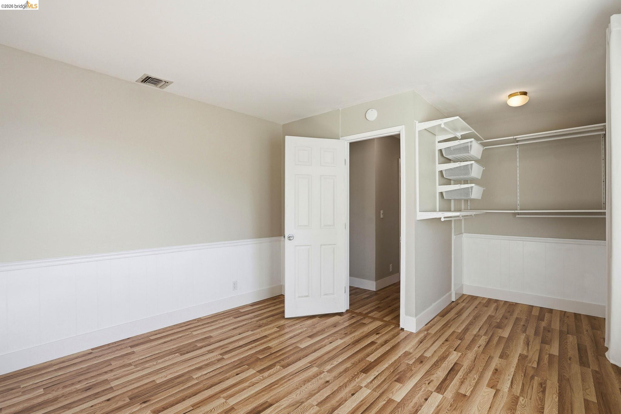 840 Key Rte Boulevard Albany, CA 94706 - Photo 31 of 42 a view of an empty room with wooden floor and a window