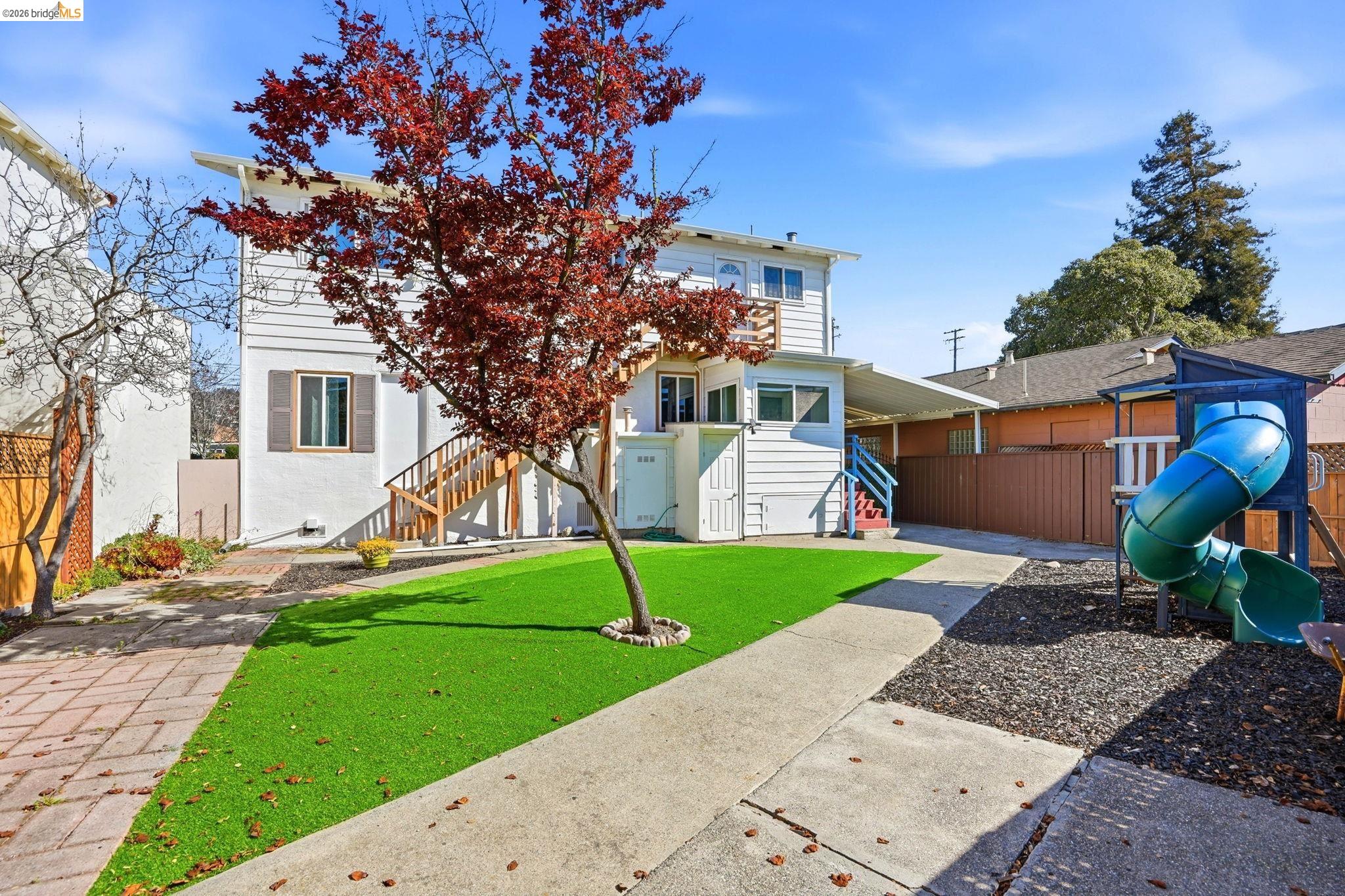 840 Key Rte Boulevard Albany, CA 94706 - Photo 41 of 42 a front view of a house with a yard and garage